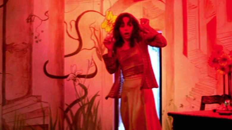 Woman shocked in red room in Suspiria