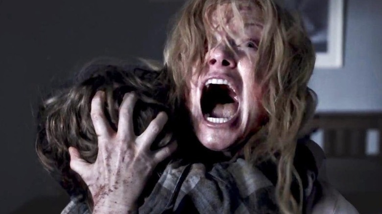 Screaming woman holds child in The Babadook