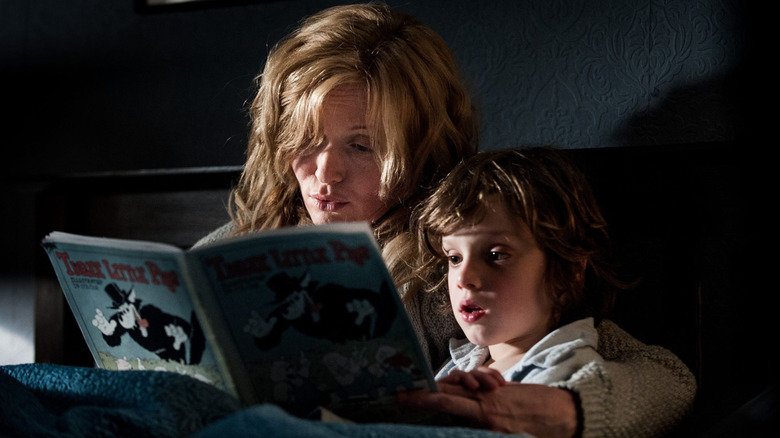 Screaming woman holds child in The Babadook