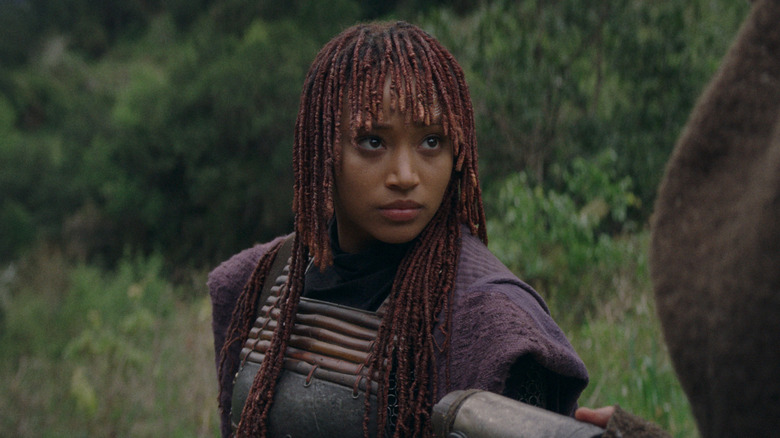 Amandla Stenberg as Mae Aniseya being handed a lightsaber in The Acolyte