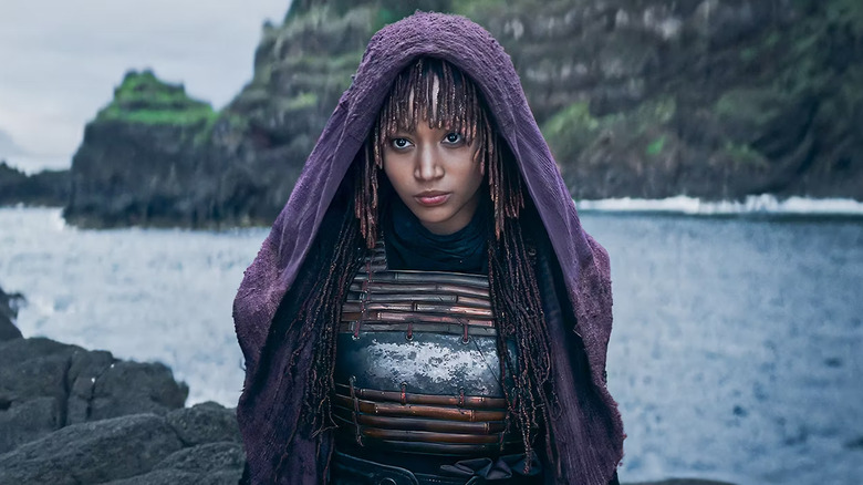 Mae standing on rocks in the ocean in Star Wars: The Acolyte