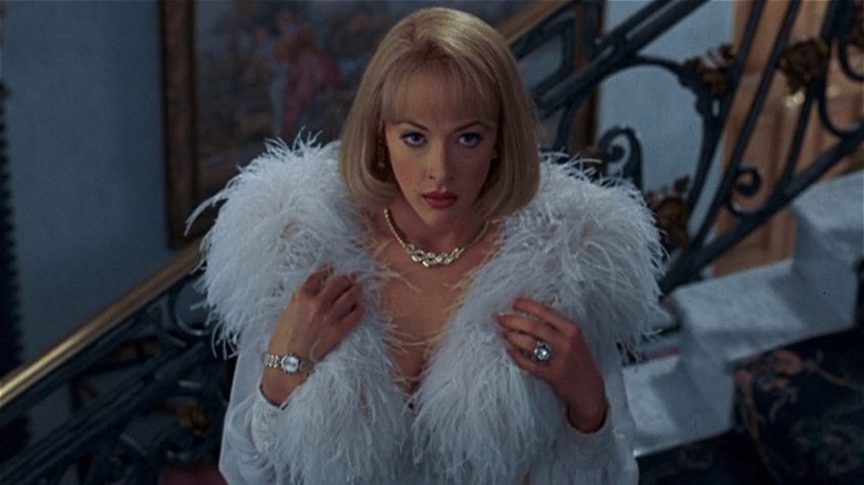 Joan Cusack stands in fur coat