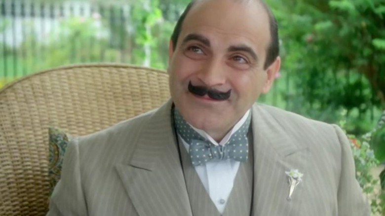 David Suchet's Hercule Poirot conversing with friends in the Wasps' Nest episode of Poirot