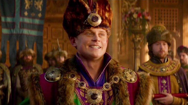 Billy Magnussen smiling as Prince Anders in Aladdin