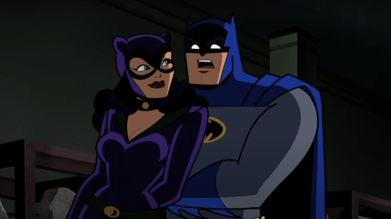 Batman looks shocked as he stands behind Catwoman in Batman The Brave and the Bold