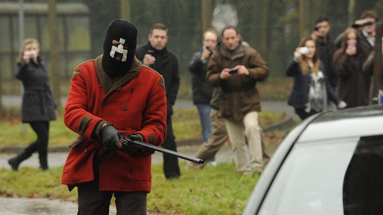 Masked man with white bear symbol