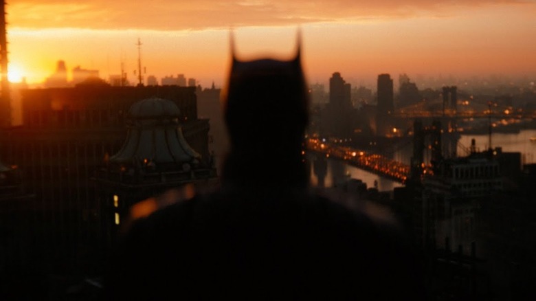The Batman costume against the Gotham skyline