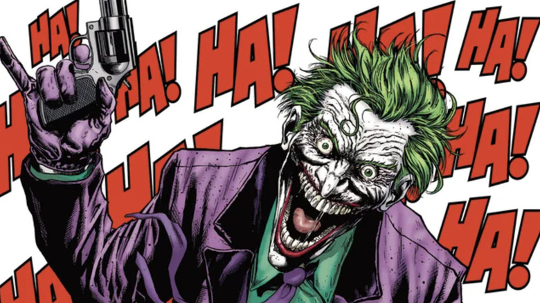 Batman comic Joker laughing manically and holding gun