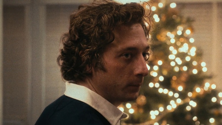 Jeremy Allen White as Carmen Berzatto, standing in front of a christmas tree in the bear