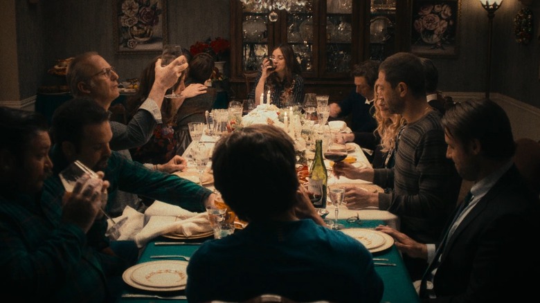 The cast of the Bear's Fishes episode sits at a dinner table eating and drinking, with Jon Bernthal's Michael Berzatto silhouetted at the head of the table