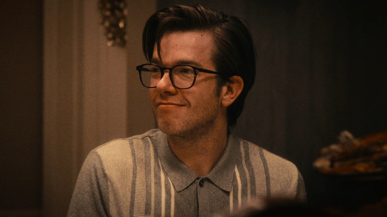 John Mulaney as Stevie, smiling at the dinner table in The Bear