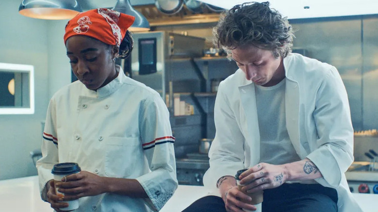 Jeremy Allen White and Ayo Edebiri holding coffee in The Bear