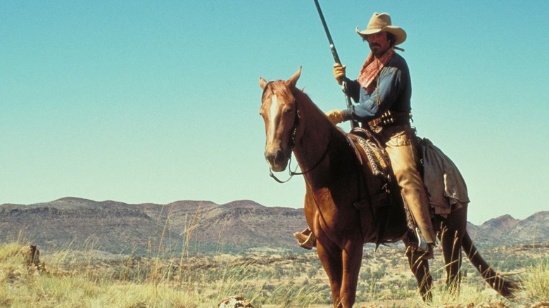 Tom Selleck in cowboy gear riding horse