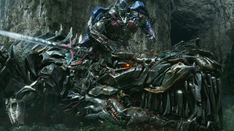 Optimus stands over Grimlock