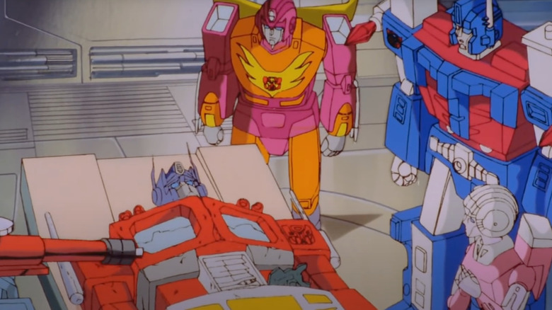 Optimus lying on a table in front of his friends