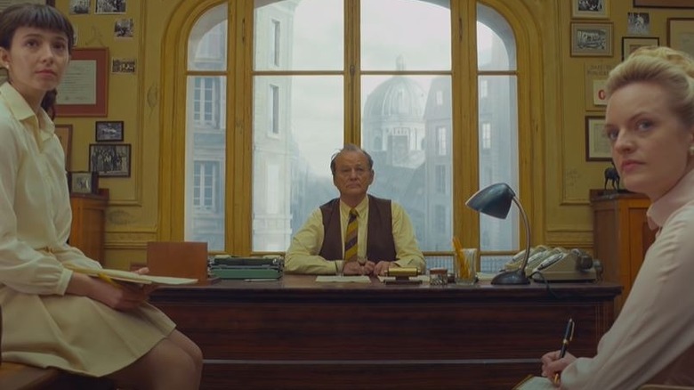 Bill Murray sits at desk in "The French Dispatch"