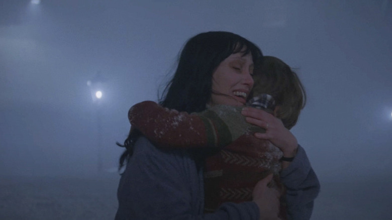 The Shining, Wendy and Danny hug in the snow outside the maze