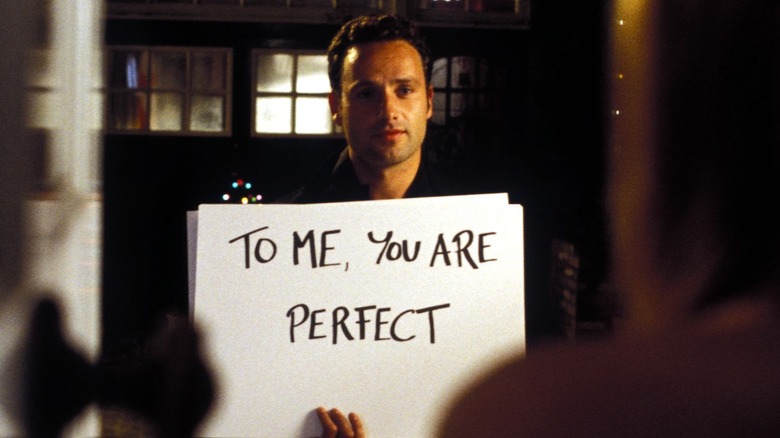 Mark holding a sign that says "To me, you are perfect" in Love Actually