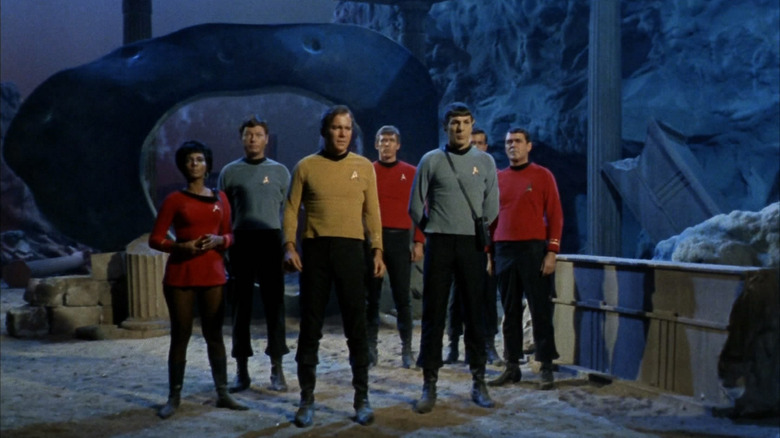 The Enterprise landing party in front of a time portal on Star Trek