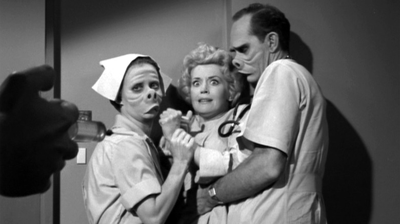 A woman being restrained in the Twilight Zone episode Eye of the Beholder