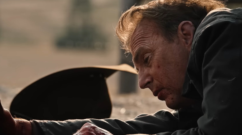 Kevin Costner como John Dutton tirado en el suelo después de recibir un disparo en el episodio Half Money de Yellowstone.