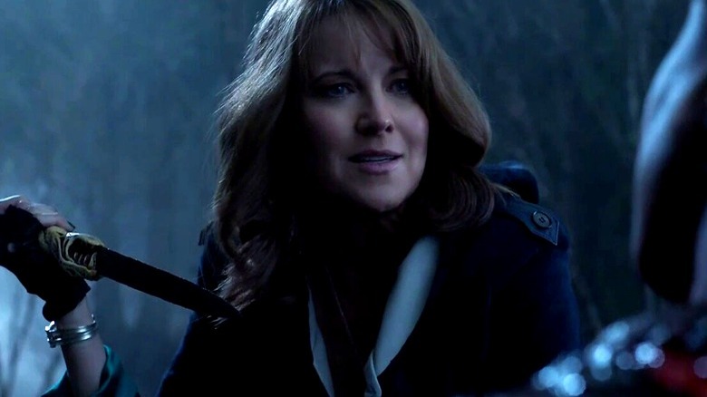 Lucy Lawless holding dagger