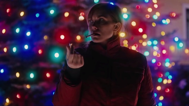 Karen smokes a cigarette in front of Christmas lights in I Trapped the Devil