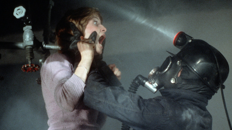 Harry Warden picks a woman up by the head in My Bloody Valentine 1981