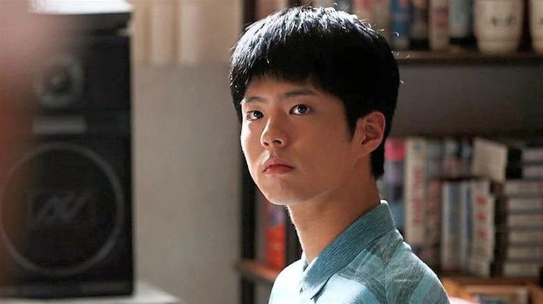 Choi Taek (Park Bo-gum) looks up in his living room in Reply 1988