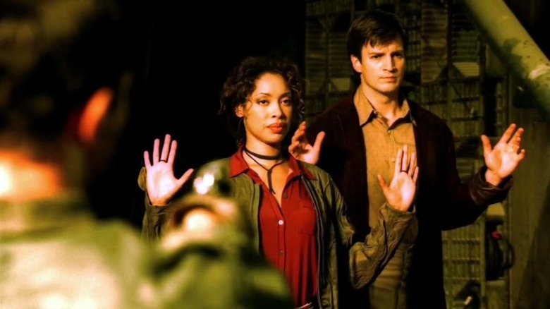 Gina Torres Nathan Fillion hands up