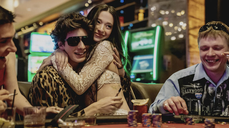 Anora hugs Vanya while he gambles in Vegas in Anora