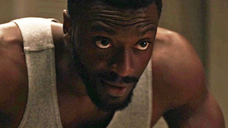 Aldis Hodge bent over in The Invisible Man