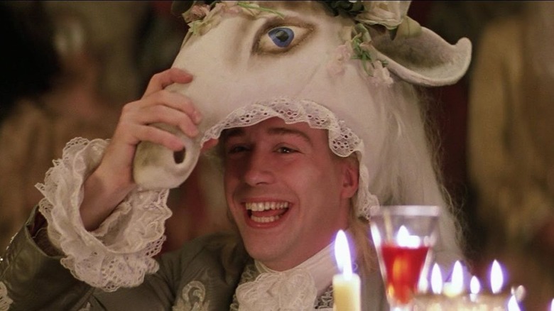 Mozart smiling and wearing a horse head mask in Amadeus