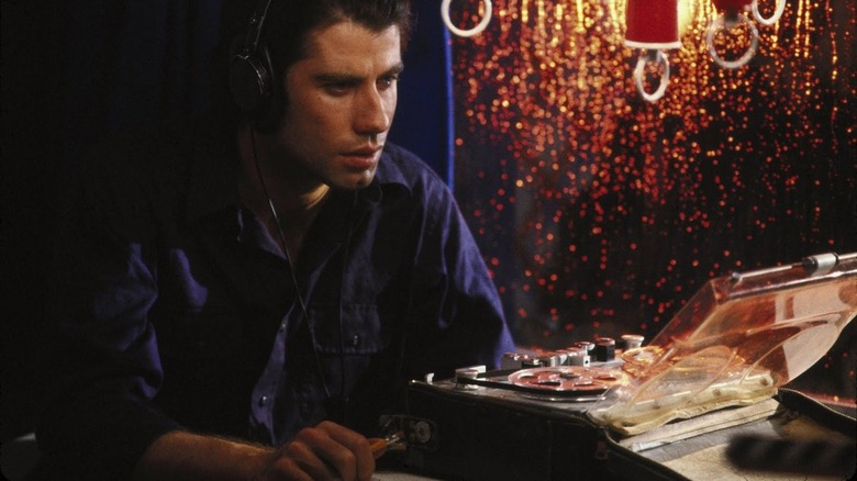John Travolta listens to recording