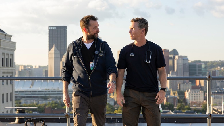 Noah Wyle's Dr. Robby walks away from a ledge with Shawn Hatosy's Dr. Abbott in The Pitt