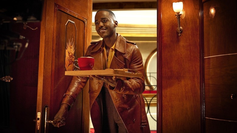 Ncuti Gatwa as the Doctor bringing room service on Doctor Who