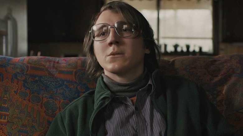 Paul Dano seated, looking away