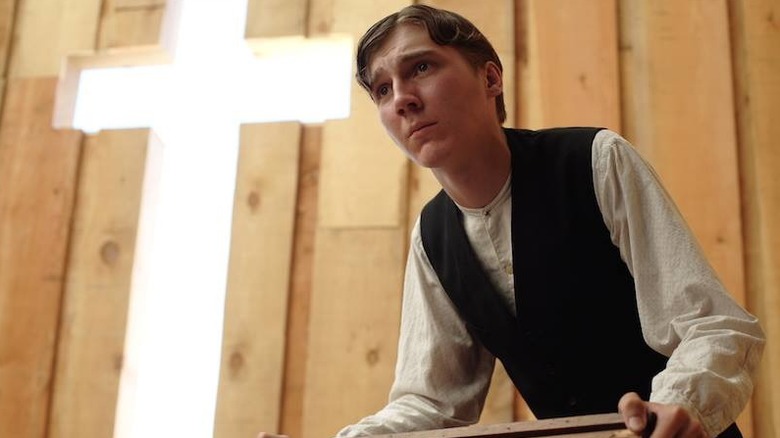 Paul Dano leaning forward, looking conflicted