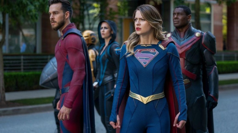 Supergirl looks on nervously