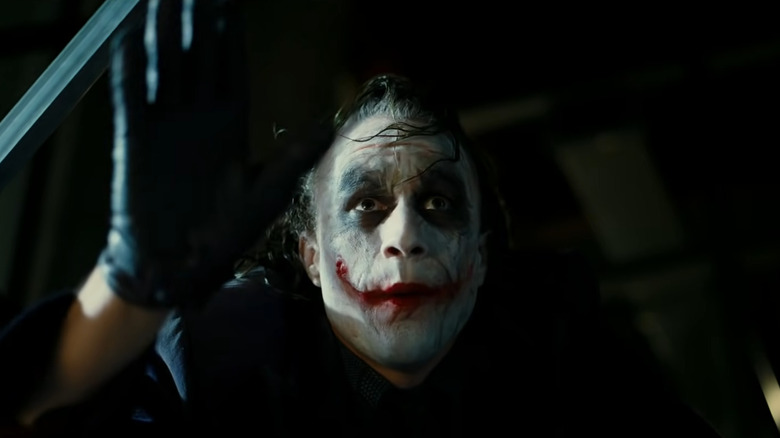 Heath Ledger smirking as the Joker