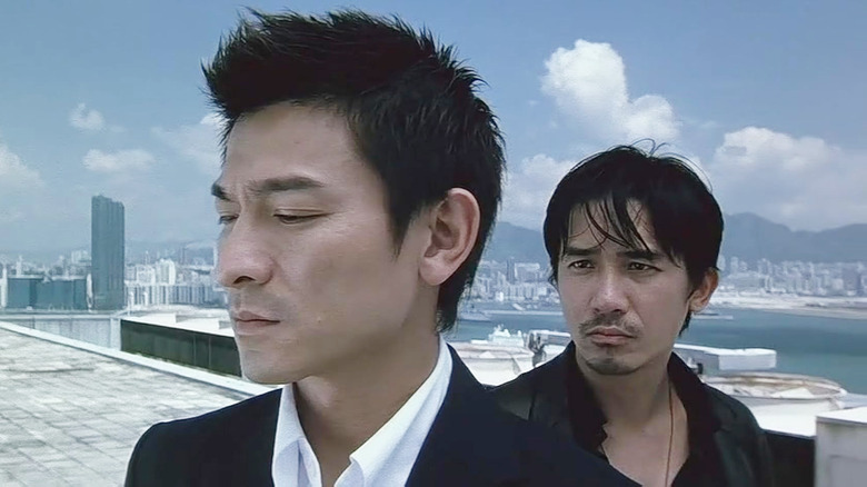 Andy Lau as Lau Kin-ming and Tony Leung as Chan Wing-yan standing on a rooftop in Infernal Affairs