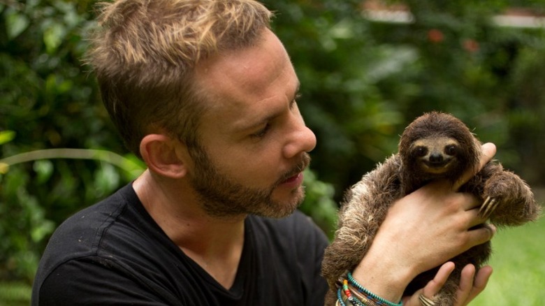 Dominic Monaghan holds a baby sloth