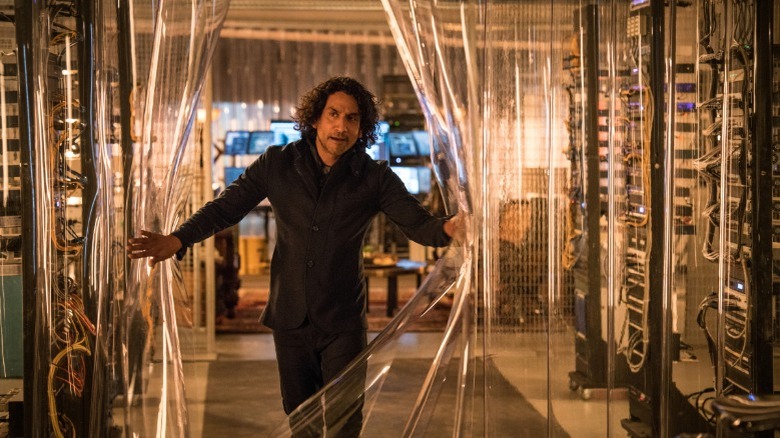 Naveen Andrews walks through plastic curtain on Sense8