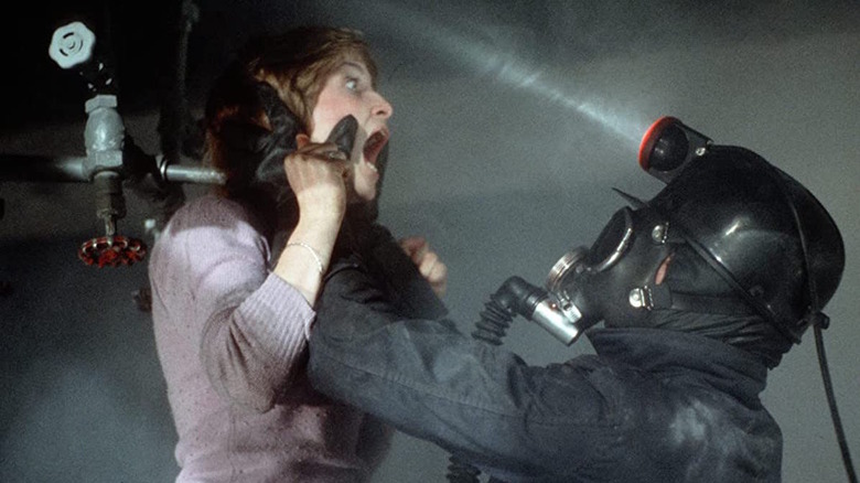 A miner thrusts a woman's head through an overhead sprinkler