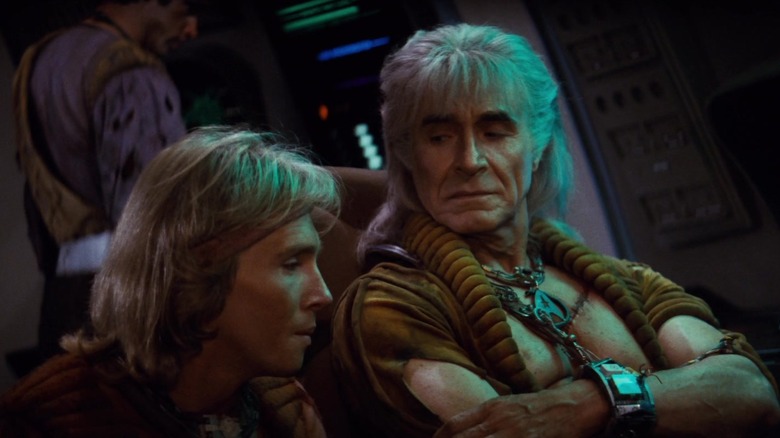 Khan Noonien Singh sits with his arms folded across his chest in Star Trek II: The Wrath of Khan