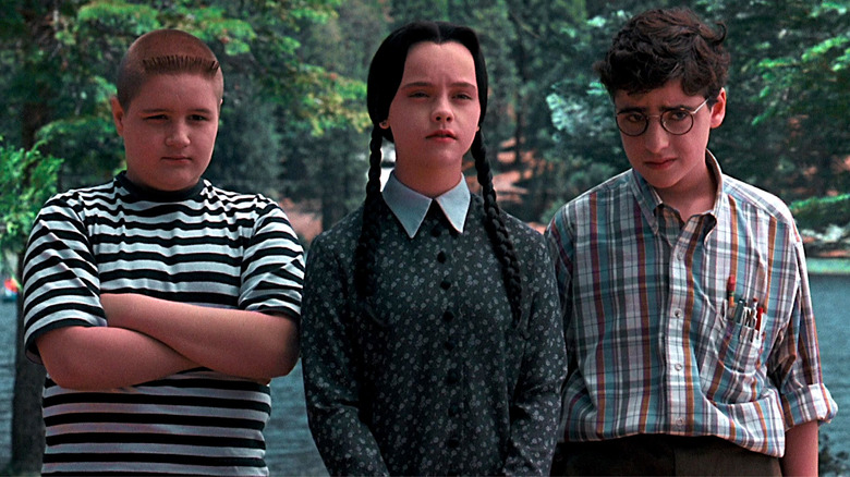 Jimmy Workman, Christina Ricci, and David Krumholtz stand together in Addams Family Values