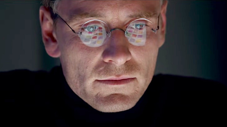 Michael Fassbender stares as the iPhone screen reflects in his glasses in Steve Jobs