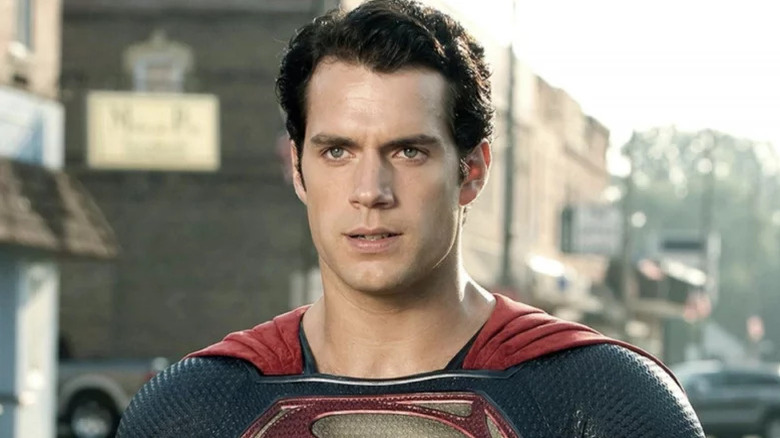 Henry Cavill's Superman stands looking intense on the street in Man of Steel