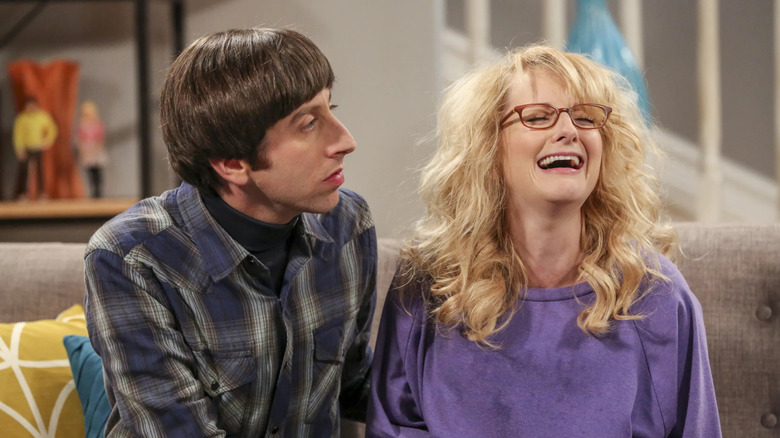 Howard and a sobbing messy Bernadette on the couch on The Big Bang Theory