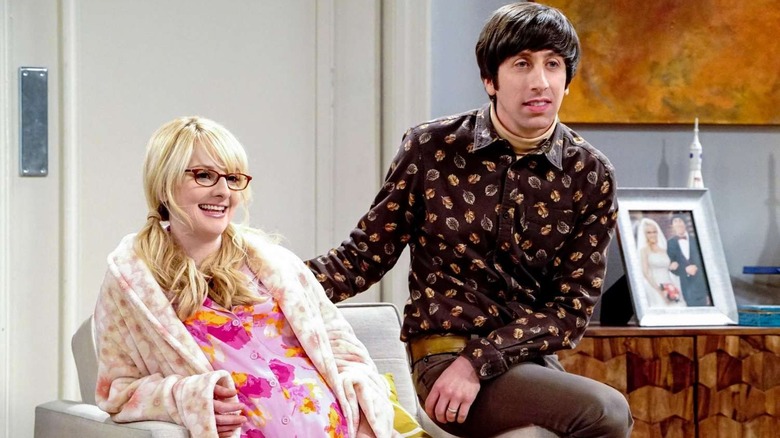 Bernadette, pregnant and sitting in an armchair, and Howard on The Big Bang Theory